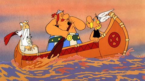 Asterix und Obelix in Amerika - die beiden paddeln in einem Kanu, Miraculix und Idefix sind mit an Bord